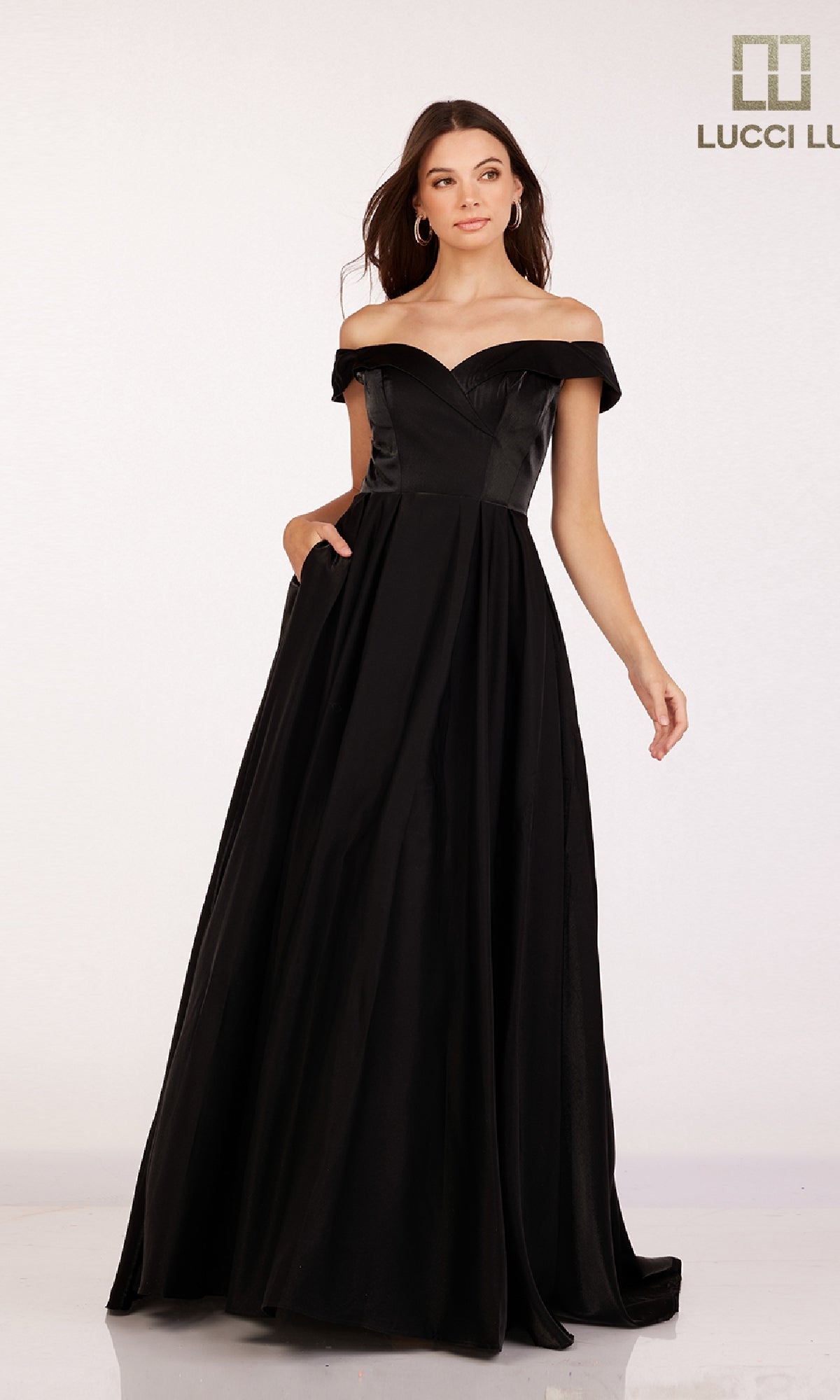 A woman models the Off-the-Shoulder Satin Prom Dress: Lucci Lu 28063 against a plain light background, with the Lucci Lu logo in the top right corner.
